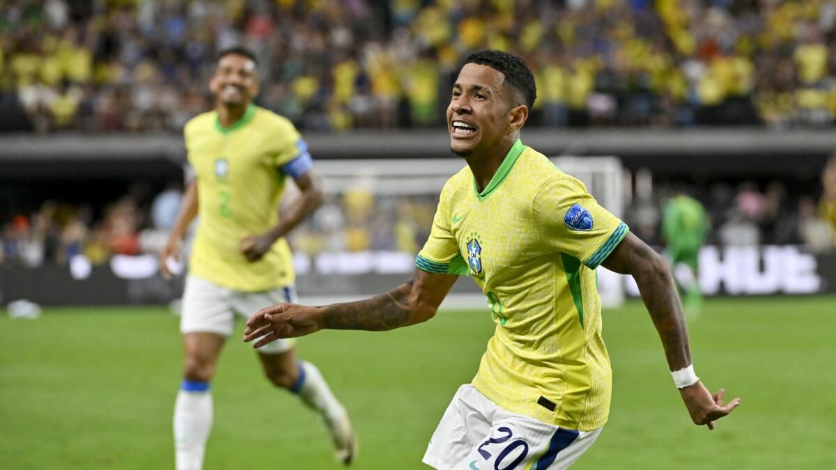 Savinho celebrating a goal scored with the Brazil national team
