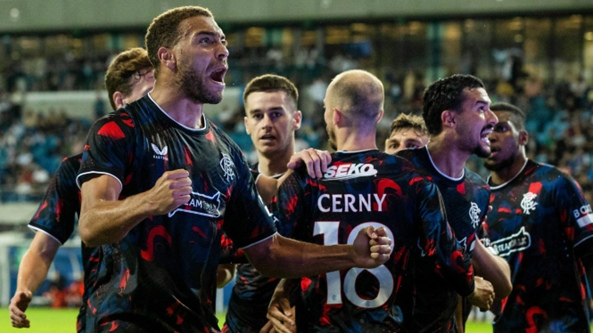 The Rangers players are celebrating a goal.