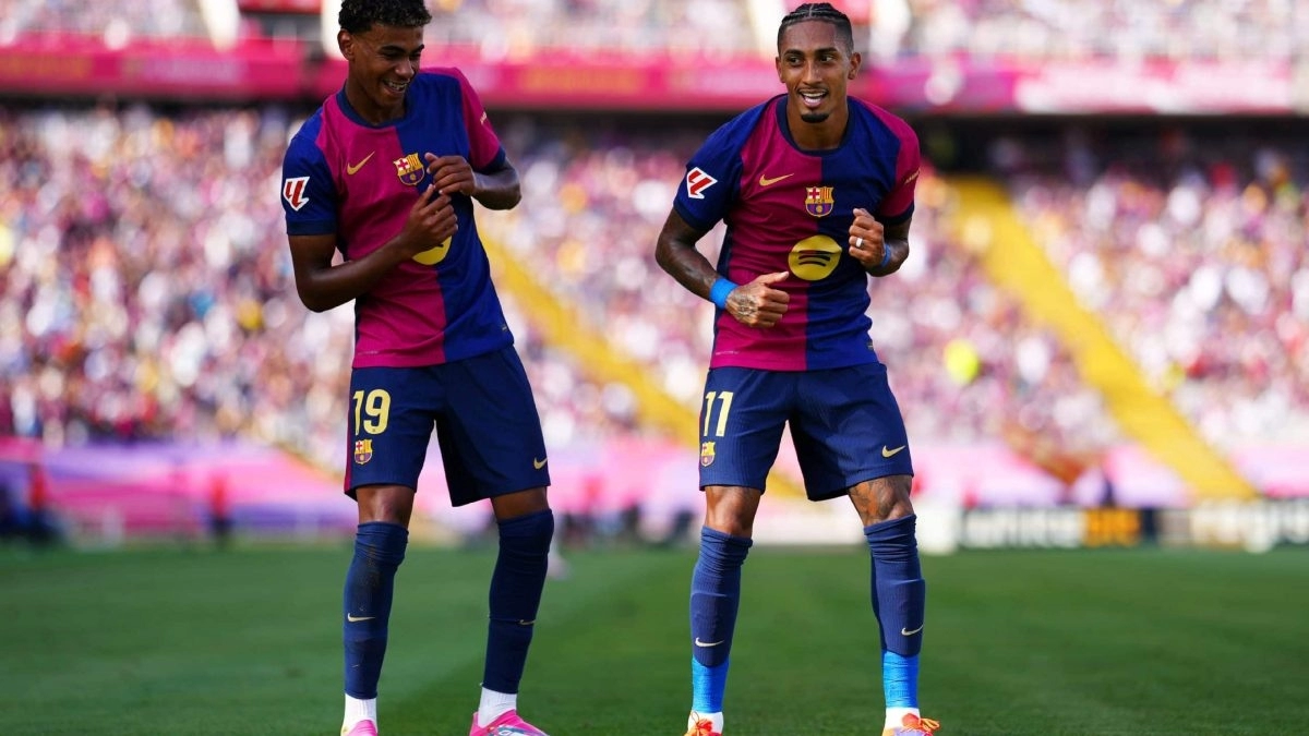 Raphinha celebrates a goal for Barcelona alongside Lamine Yamal