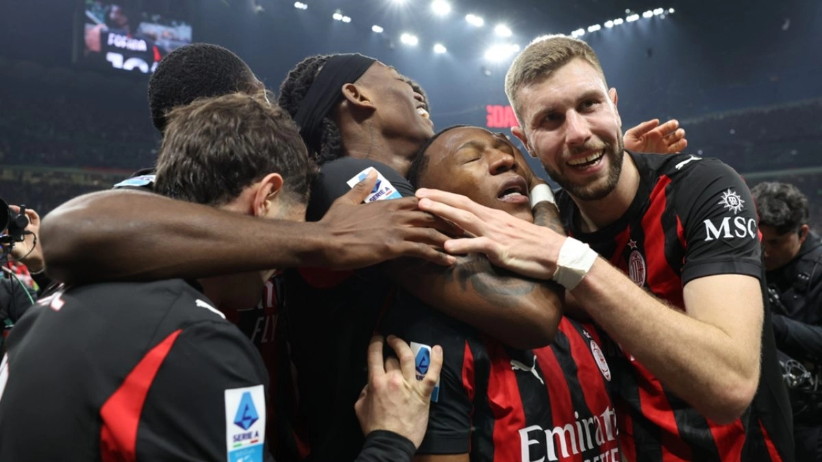 The Milan players celebrate a goal