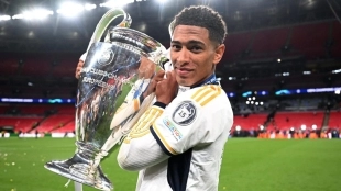 Jude Bellingham poses with the Champions League trophy.